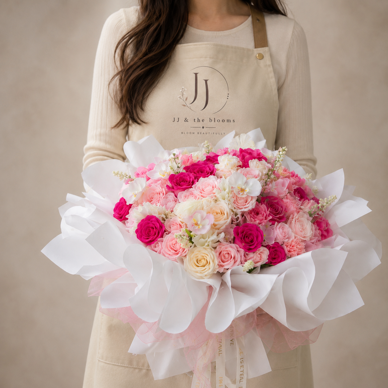 Pink soap flower bouquet held by a JJ & The Blooms florist